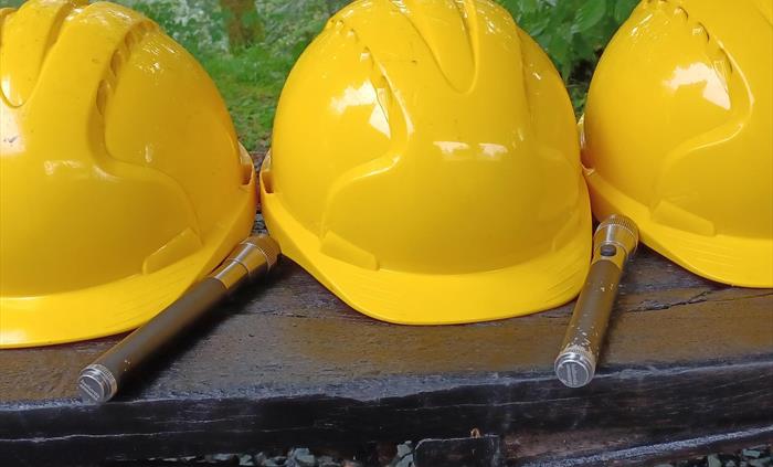 Yellow hard hats and hand torches
